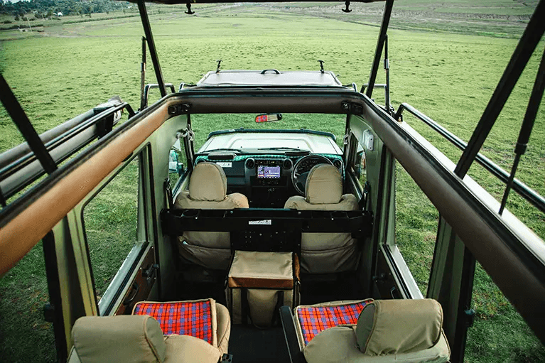 Safari vehicle interior showing charging ports and comfortable seats