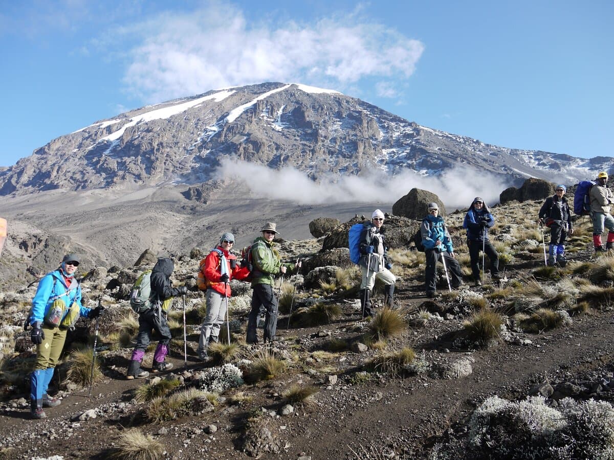 Climbers trekking towards Kilimanjaro's snow-capped summit